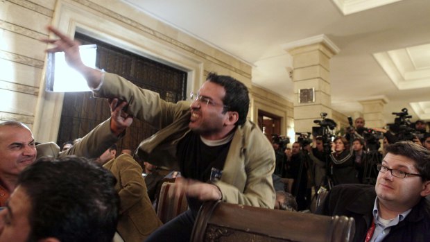 Iraqi journalist Muntadhar al-Zaidi throws a shoe at President George W. Bush during a new conference in 2008. 