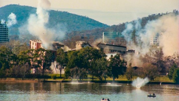 Falling debris rains down into Lake Burley Griffin following the botched Royal Canberra Hospital implosion.