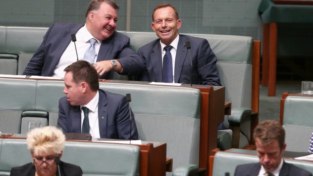 Liberal MP Craig Kelly in discussion with former prime minister Tony Abbott  during question time on Monday.