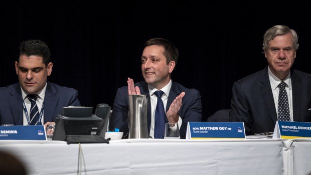 Liberal leader Matthew Guy, flanked by state director Nick Demiris and president Michael Kroger at the state conference in April. 