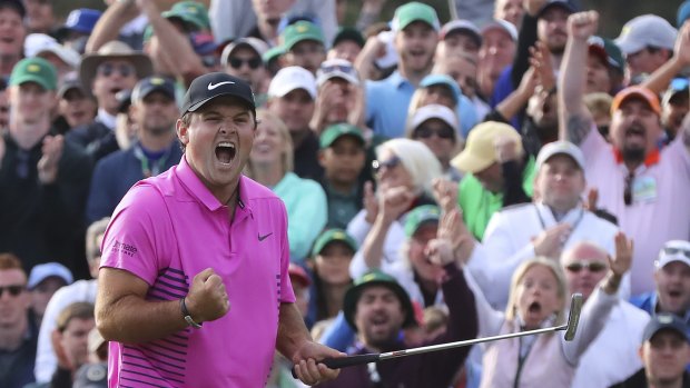 In the pink: Patrick Reed celebrates after draining the winning putt at the Masters.