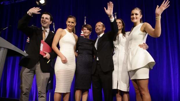 A gatecrasher poses for photos with the Abbott family during the Coalition  election night function in Sydney on Saturday.