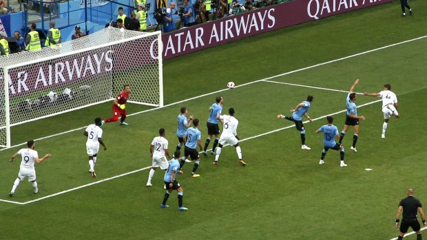 France's Raphael Varane, right, scores the opening goal.