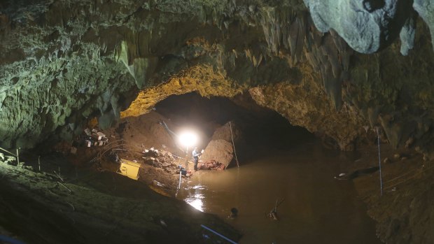 Thai rescuers work at the entrance to a cave early on Friday.