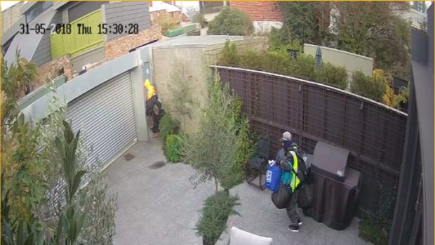 The offenders flee carrying possessions from the Carlton home. 