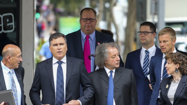 Dreamworld CEO Craig Davidson (second left) arrives with lawyers to the pre-inquest hearing into the fatal accident at the Dreamworld theme park, at the Brisbane Coroners Court in Brisbane, Tuesday, April 3, 2018. 