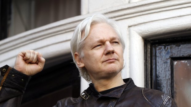 Julian Assange greets supporters outside the Ecuadorian embassy, his "home", in London in 2017.