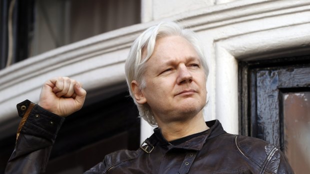 Julian Assange greets supporters outside the Ecuadorian embassy, his "home", in London in 2017.