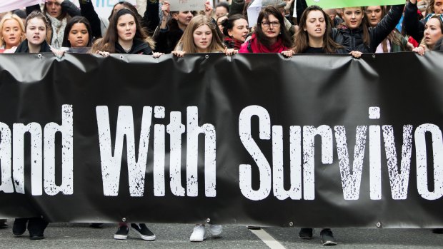 People take part in a protest in Dublin, in support of the woman at the centre of a rape trial after two Ireland ruby players were acquitted. 