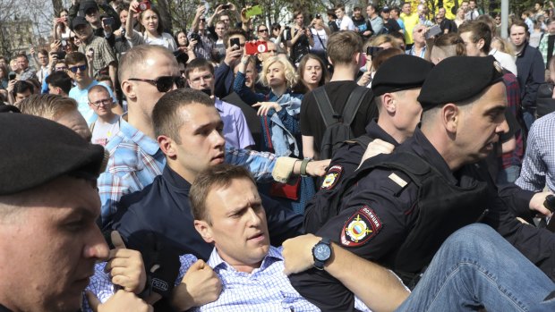 Russian police carrying struggling opposition leader Alexei Navalny, centre, at a demonstration against President Vladimir Putin in Pushkin Square in Moscow on Saturday.