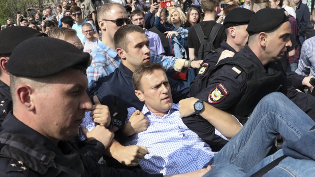 Russian police carrying struggling opposition leader Alexei Navalny, centre, at a demonstration against President Vladimir Putin in Pushkin Square in Moscow on Saturday.