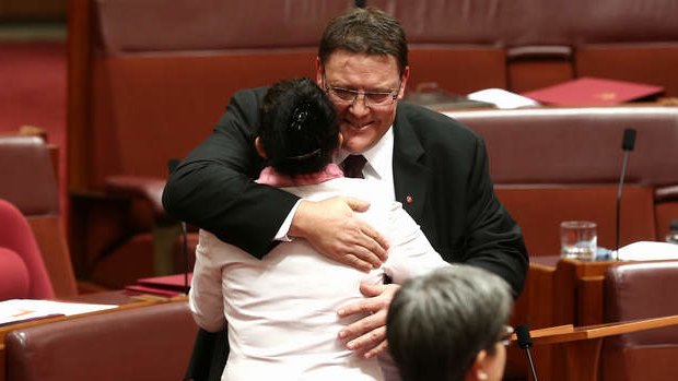 PUP Senator Glenn Lazarus is embraced by PUP Senator Jacqui Lambie after delivering his first speech. Photo: Alex Ellinghausen