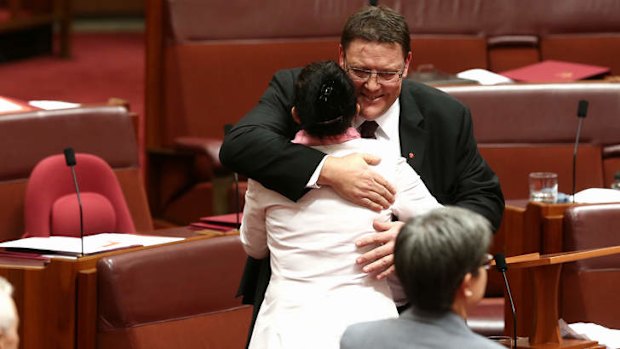 PUP Senator Glenn Lazarus is embraced by PUP Senator Jacqui Lambie after delivering his first speech. Photo: Alex Ellinghausen