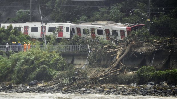 A train remains derailed by a landslide caused by heave rains in Karatsu, Saga prefecture, Japan, on Saturday.