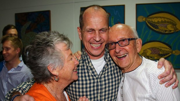 Welcome home son ... Australian journalist Peter Greste is hugged by his mother Lois, left, and father Juris, right, after his arrival in Brisbane.