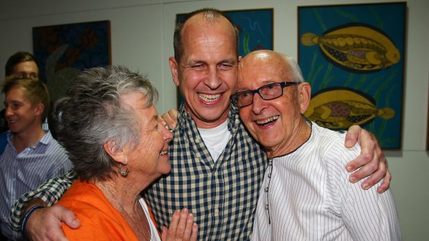 Welcome home son ... Australian journalist Peter Greste is hugged by his mother Lois, left, and father Juris, right, after his arrival in Brisbane.