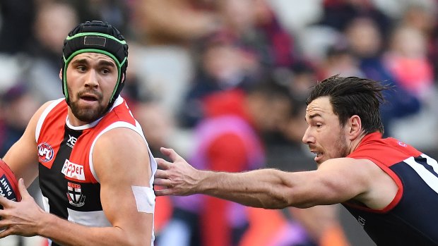 Run and carry: Paddy McCartin charges past Demon Michael Hibberd.