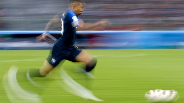 Bleus blur: Mbappe runs with the ball against Belgium in the semi-final.