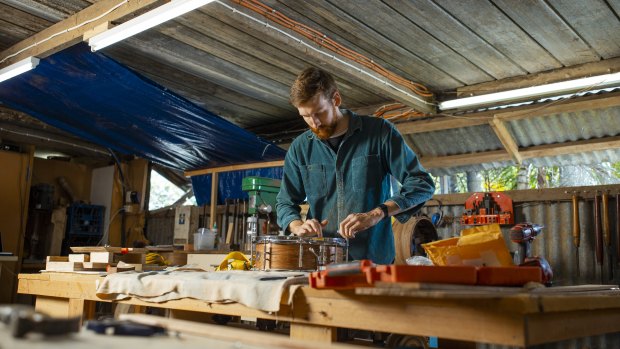 Drum maker Beau Jorgensen at work in his woodworking shed creating a steam-bent drum.