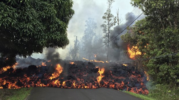 A lava flow moves across Makamae Street in the Leilani Estates subdivision near Pahoa on the island of Hawaii.