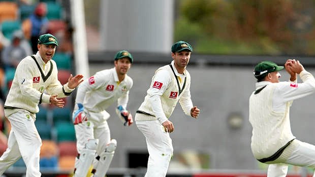 Final wicket ... Michael Clarke, Matthew Wade and Phillip Hughes of Australia look on as Michael Hussey takes the catch to dismiss Chanaka Welegedara.