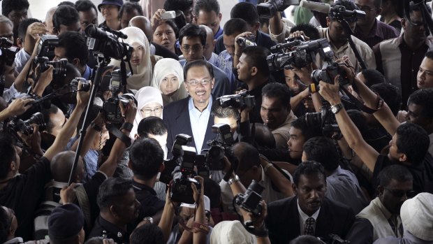 Then Malaysian opposition leader Anwar Ibrahim, centre, is surrounded as he arrives at court in 2008.