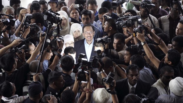 Then Malaysian opposition leader Anwar Ibrahim, centre, is surrounded as he arrives at court in 2008.