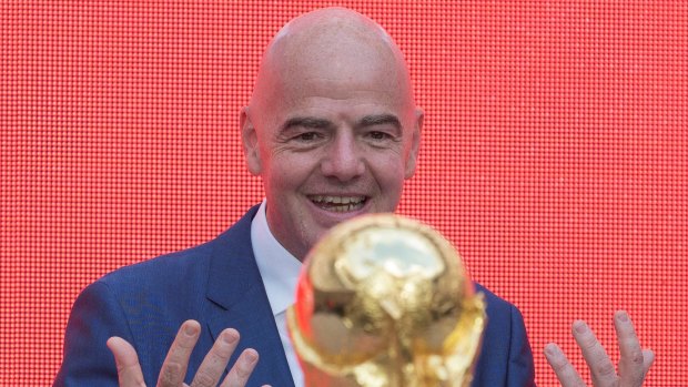 FIFA President Gianni Infantino gestures looking at the FIFA World Cup trophy at Moscow's Luzhniki Stadium.