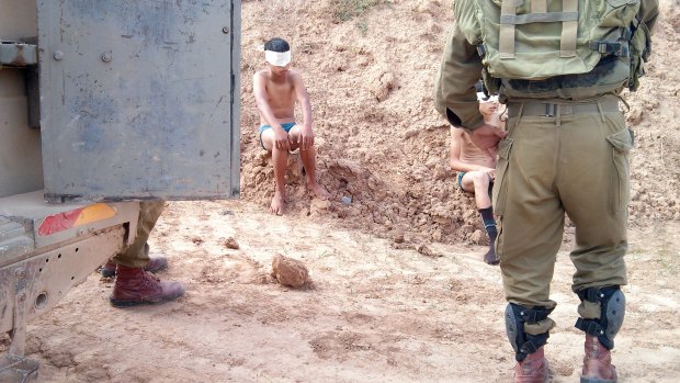 Children are blindfolded and handcuffed by soldiers and taken to police stations.  Photo taken by IDF soldier on a occupied territory mission.