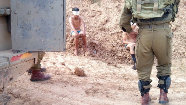 Children are blindfolded and handcuffed by soldiers and taken to police stations.  Photo taken by IDF soldier on a occupied territory mission.