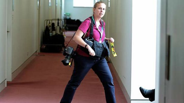 A News Corp Australia photographer loiters in the press gallery outside the office of Guardian Australia, waiting to photograph Editor-in-chief Katharine Viner, at Parliament House. Photo: Alex Ellinghausen