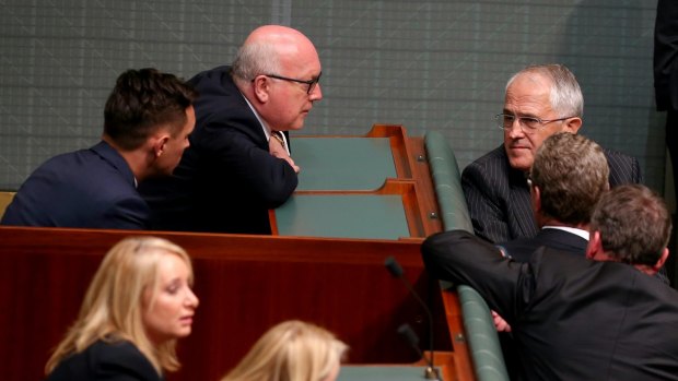 Attorney-General Senator George Brandis and Prime Minister Malcolm Turnbull in discussion during a division in the House of Representatives on Monday.
