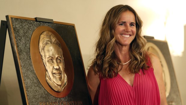 Brandi Chastain with the plaque.