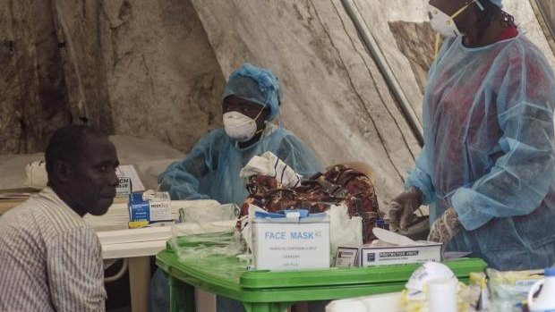 Health workers take blood samples for Ebola testing at a screening tent in the local government hospital in Kenema, Sierra Leone.