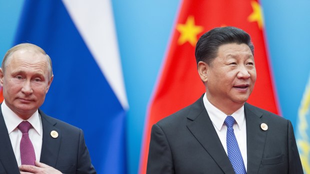 Chinese President Xi Jinping, right, and Russian President Vladimir Putin walk to attend talks at the Shanghai Cooperation Organisation.