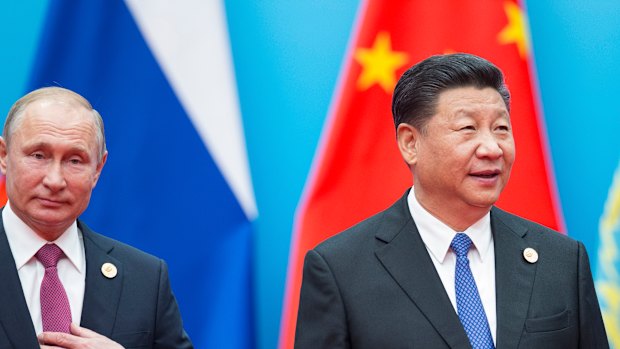 Chinese President Xi Jinping, right, and Russian President Vladimir Putin walk to attend talks at the Shanghai Cooperation Organisation.