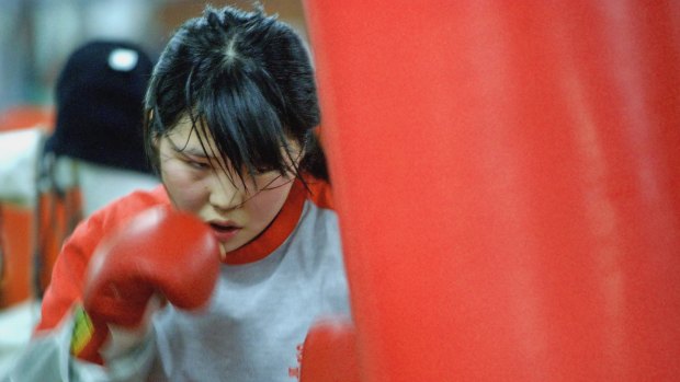 Former North Korean defector Choi Hyun Mi, 14,  beats a sandbag during her training at the Dongbu Unsung Gymnasium in Seoul.