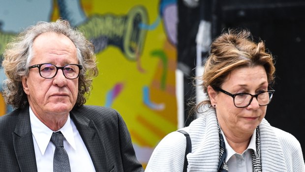 Geoffrey Rush and wife Jane Menelaus outside the Federal Court in Sydney on Wednesday.