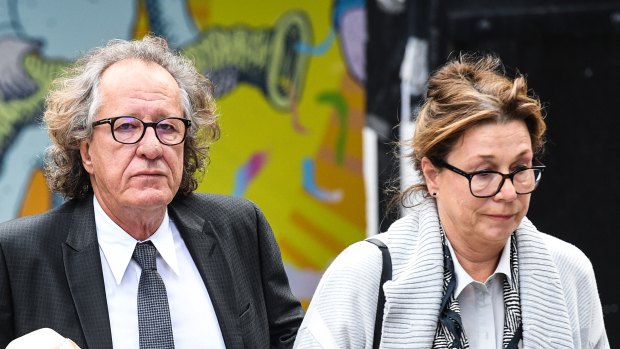 Geoffrey Rush and wife Jane Menelaus outside the Federal Court in Sydney on Wednesday.