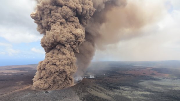 A red-brown ash plume steams from the Hawaiian volcano.