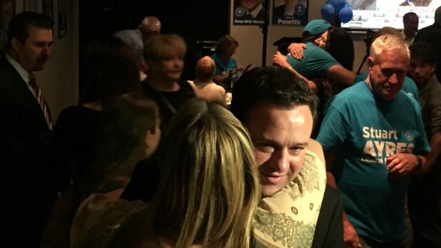 Stuart Ayres hugs federal MP Fiona Scott at his victory party.