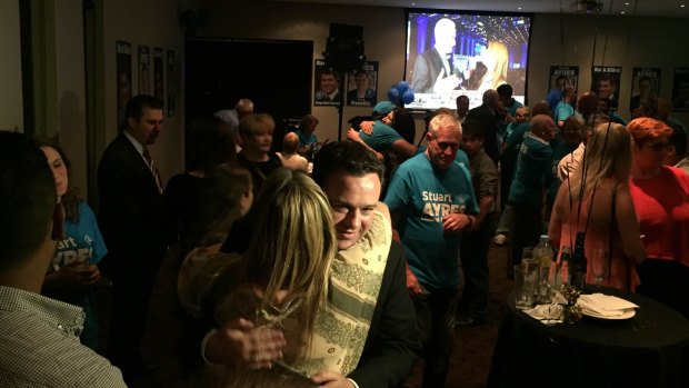 Stuart Ayres hugs federal MP Fiona Scott at his victory party.