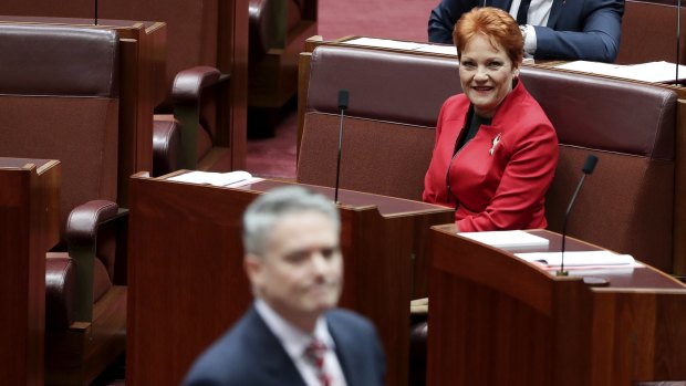 Minister for Finance Mathias Cormann walks past Senator Pauline Hanson in the Senate