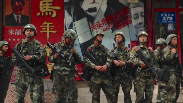 Armed police patrol the streets in Urumqi, Xinjiang, China.