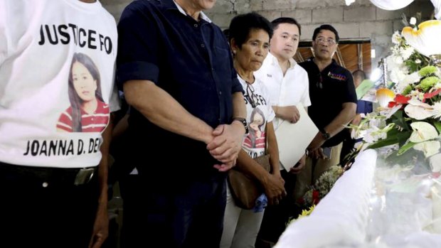 Philippine President Rodrigo Duterte, second from left, attends the wake for the overseas worker killed in Kuwait, Joanna Demafelis in Iloilo city, central Philippines. 