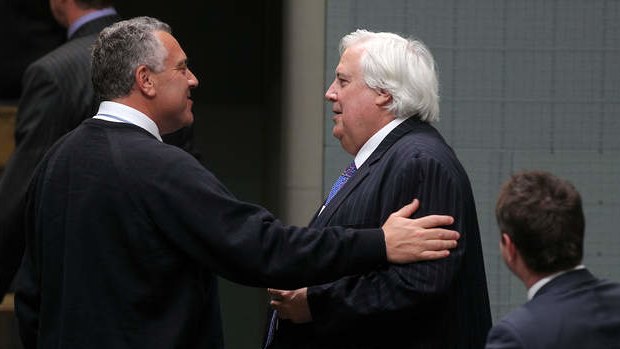 Palmer United Party leader Clive Palmer and Treasurer Joe Hockey depart after the Carbon Tax Repeal Bill passes the lower house. Photo: Alex Ellinghausen