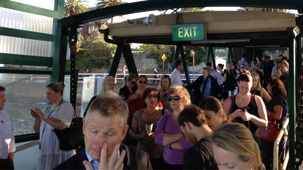 Commuters crowd a ferry stop in an attempt to bypass traffic into the city on Thursday.