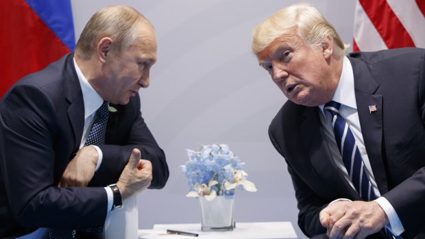 Donald Trump, here with Vladimir Putin at the G20 Summit in Hamburg last year, said he believed Putin when Putin said he didn't do it.