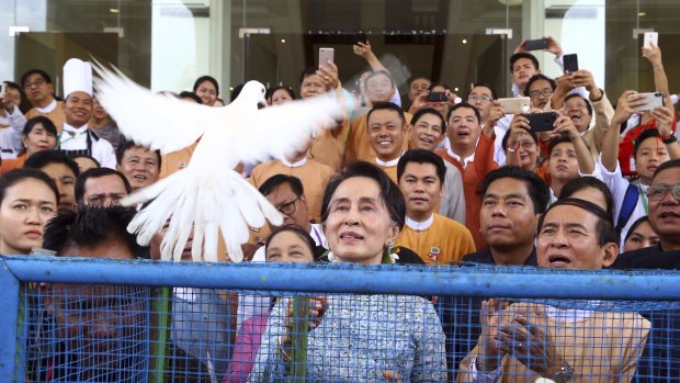 Myanmar's leader Aung San Suu Kyi, centre, releases a white dove  on her birthday last week.