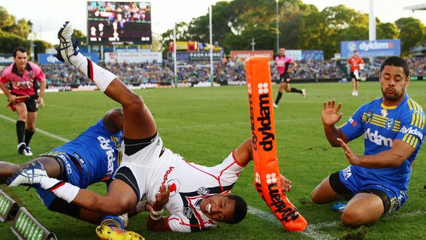 Glen Fisiiahi is tackled over the sideline attempting to score against Parramatta.